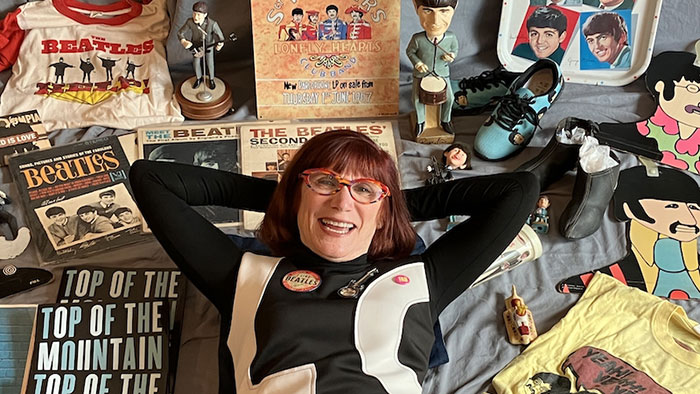 Author Laurie Jacobson surrounded by some of her Beatles memorabilia photo- credit Jon Provost