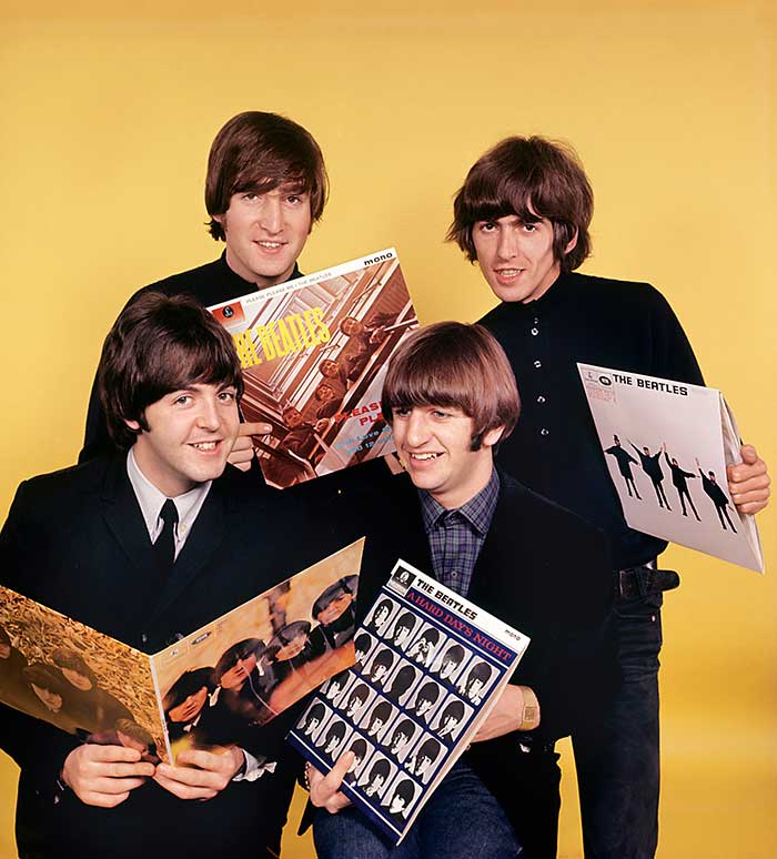 Beatles holding albums